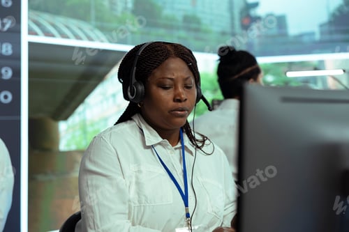 Preview: African american woman looks at real time surveillance footage