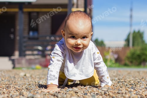 Preview: Cute baby boy crawling at playground outdoors