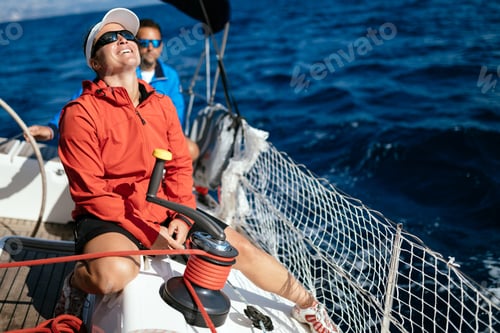 Preview: Attractive strong woman sailing with her boat
