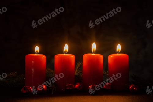 Preview: New year and Christmas preparation. Four red advent candles burning in dark room. Handmade eco