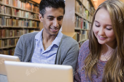 Preview: Students using laptops in library