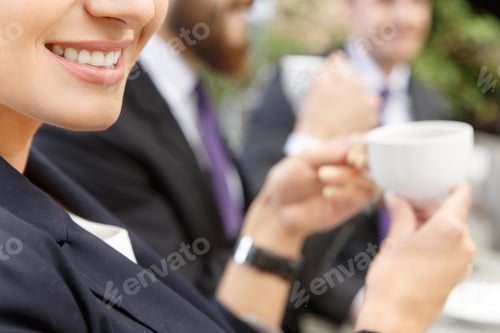 Preview: Smiling woman drinking coffee on business meeting
