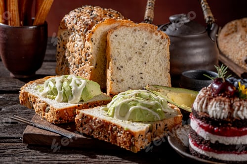 Preview: Different types of bread Topped with avocado, cheese, butter and olives, it showcases fresh and deli