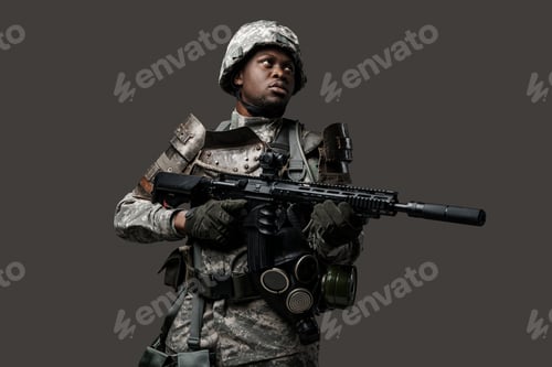 Preview: Army soldier of african ethnic with rifle against grey background