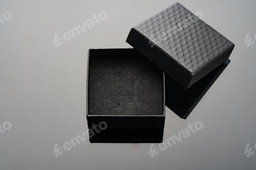 Preview: Empty black open jewelry box on glass background