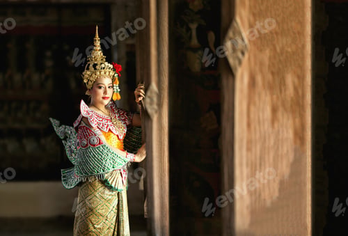 Preview: Portrait of Thailand dancer in Kinnaree costume dancing against the temple wall