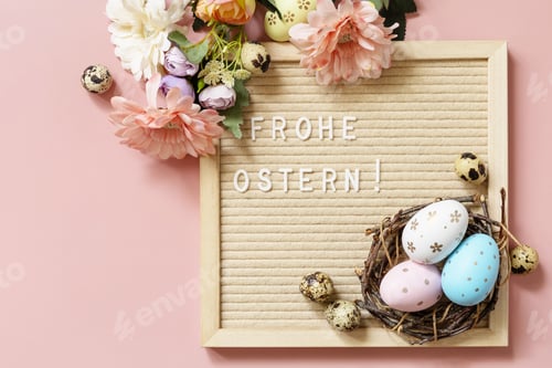 Preview: Letter board, colorful eggs and green branches on a pink background.