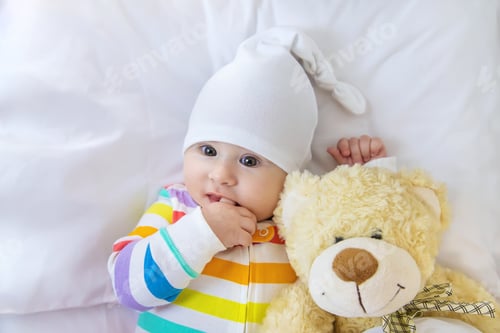 Preview: Baby puts his hands in his mouth. Selective focus.