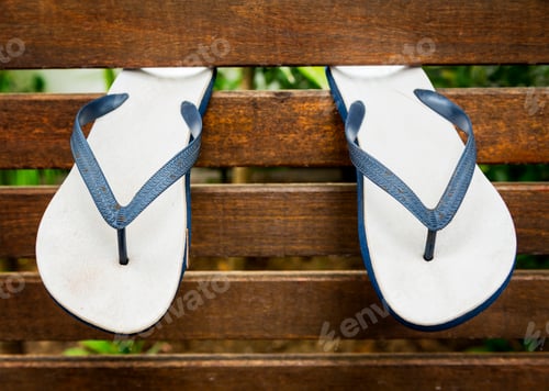 Preview: Blue Flip-Flops on a Weathered Wooden Bench