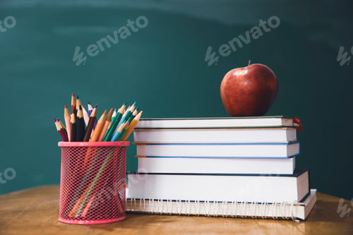 Preview: Pencils and book and blackboard. Education concept.