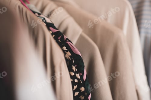 Preview: Stack collection of cotton clothes in wardrobe closeup. Homemade cloth set.