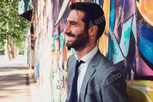 Preview: urban portrait of a smiling and elegant confident man