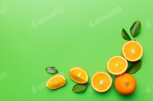 Preview: fresh Fruit orange slices on colored background. Top view.