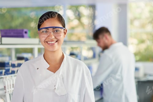 Preview: Scientist wearing safety glasses smiling at camera