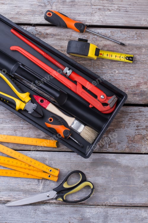 Preview: Tool box with different tools on wooden background.