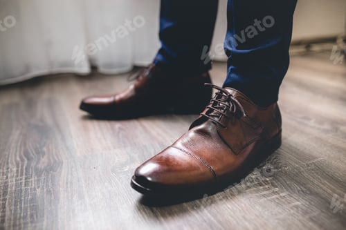 Preview: Closeup of a groomsman wearing cap toe shoes