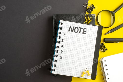 Preview: top view open notepad with note and numbers inside on dark-yellow background office success business