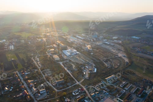 Preview: Aerial view of factory in the sunset.