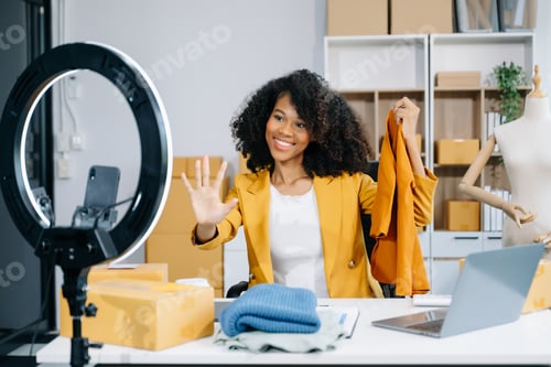 Preview: Fashion blogger concept, Young women selling clothes on video streaming.Startup small business SME