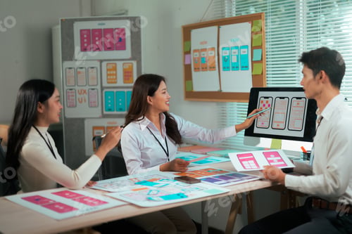 Preview: UI UX design team collaborating developing app wireframes