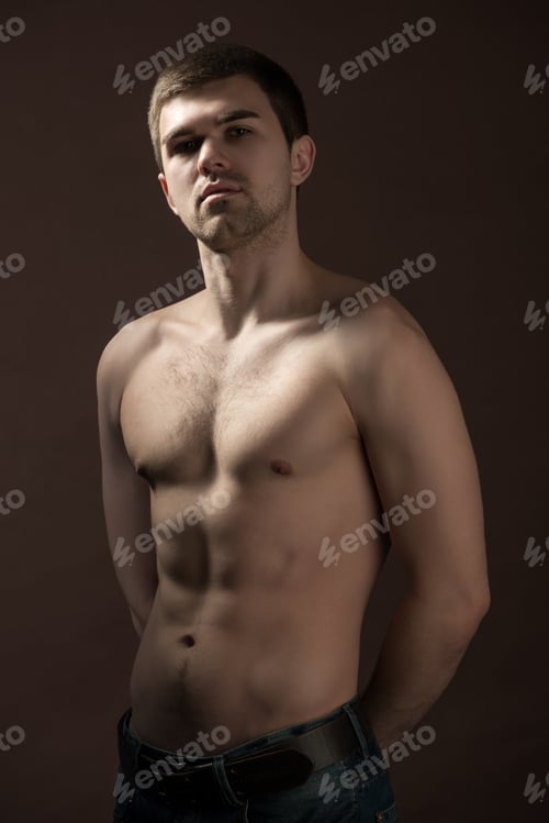 Preview: Young man model in brown underpants standing and showing his body