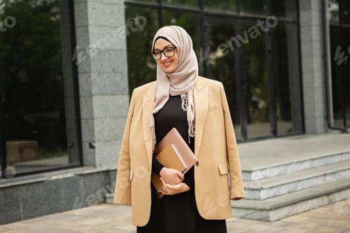 Preview: modern stylish muslim woman in hijab in city street