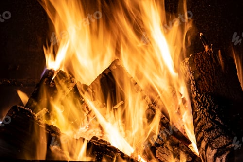 Preview: Fire orange tongues on black background in a brick fireplace