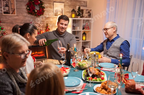 Preview: Husband pouring wine for his father in law