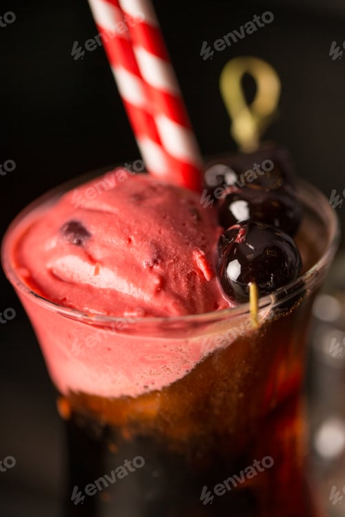 Preview: Closeup of black cherry cocktail with straw