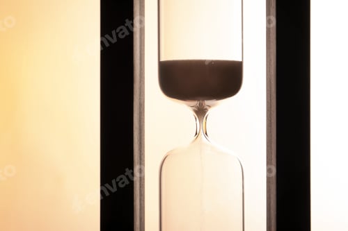 Preview: Hourglass with flowing sand on light background. Time management