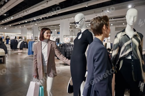 Preview: Two young elegant women friends engaged in shopping tourism