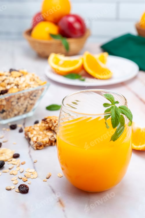 Preview: Closeup shot of a fresh juice with fruits in the background