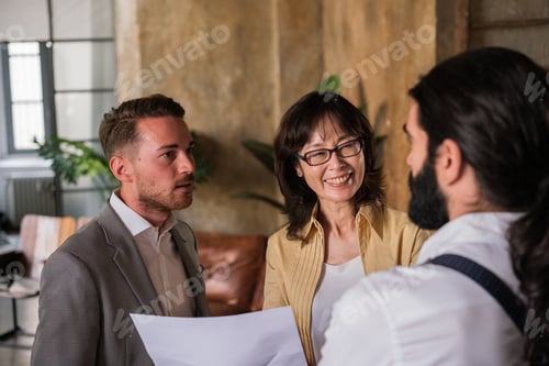 Preview: Group of business people standing analyzing data graphs