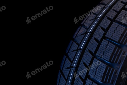 Preview: winter tire tread on black background close up