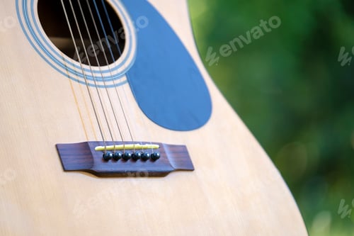 Preview: Acoustic guitar outdoors on greenery background. Concept of calm music