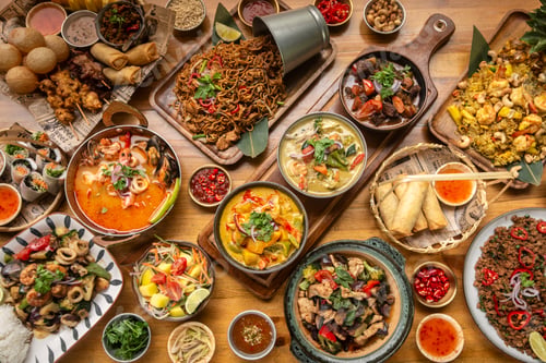 Preview: many different thai food dishes on table in modern restaurant in bangkok thailand