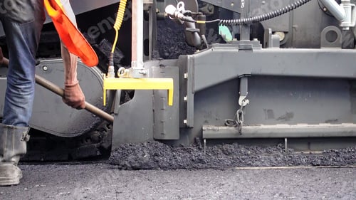 Preview: Road construction. Applying new hot asphalt.