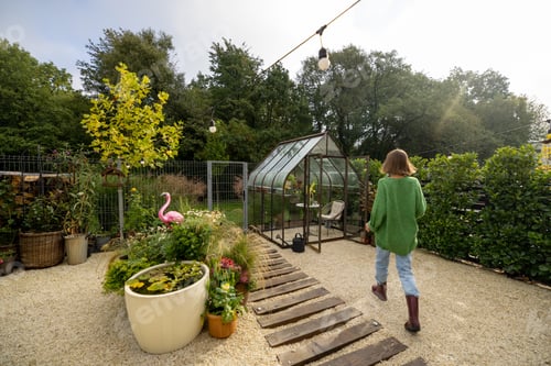 Preview: Woman gardening in beautiful and tiny yard