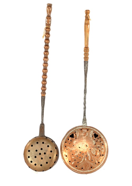 Preview: Vertical shot of copper slotted spoons with holes isolated on white background