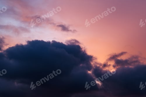 Preview: Horizontal photograph of pink clouds in overcast weather at sunset. Romantic sky.