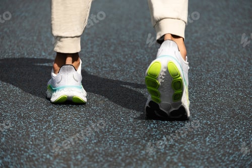 Preview: Athlete legs in white sneakers on outdoor sports ground. Workout. Close up. Outdoors.