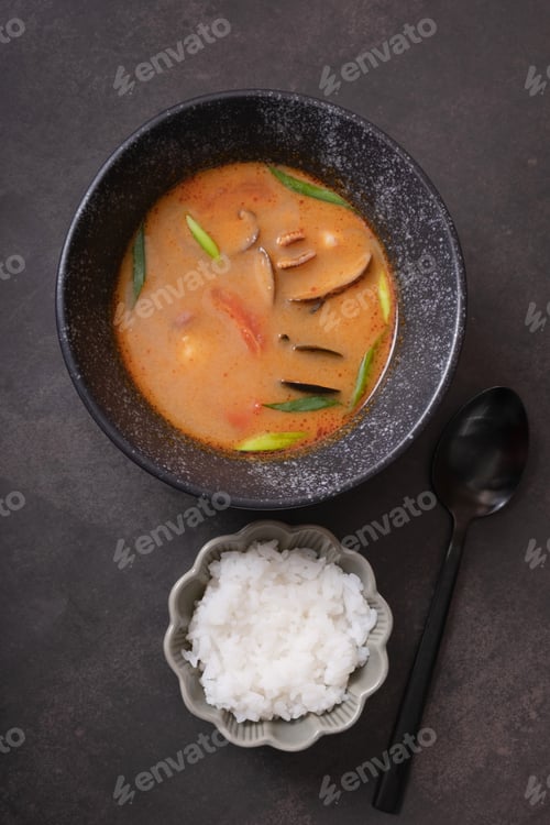 Preview: Tom yum soup and rice on dark background top view