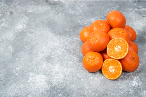 Preview: Juicy orange fruits with slices on stone background