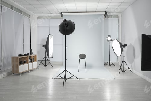 Preview: Empty chair and professional equipment in photographer's studio