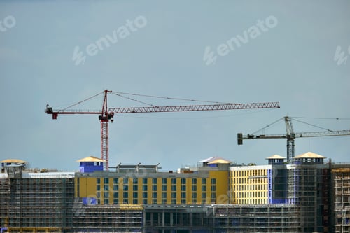Preview: Tower lifting cranes at high residential apartment buildings construction site.