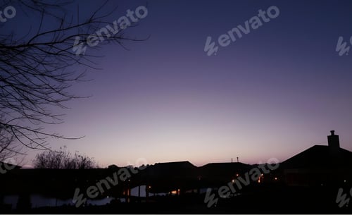 Preview: Silhouette of buildings and trees at dusk.