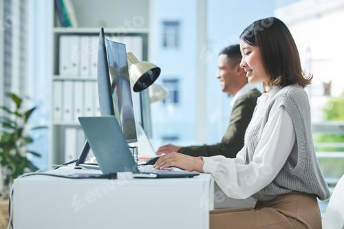 Preview: Business, planning and asian woman on laptop and computer in office for research or strategy in cow