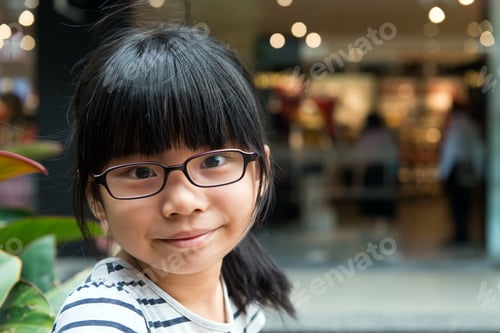 Preview: Cute Asian Chinese girl with glasses in park
