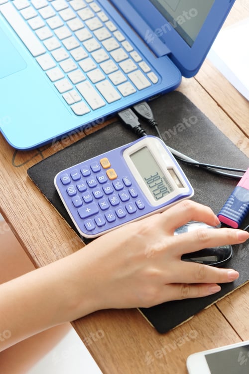 Preview: close up female hands of accountant with calculator
