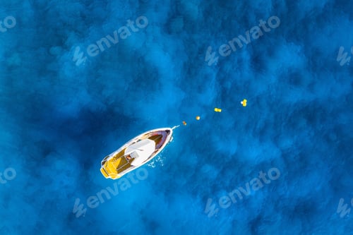 Preview: Aerial view of alone boat in blue sea at sunset in summer